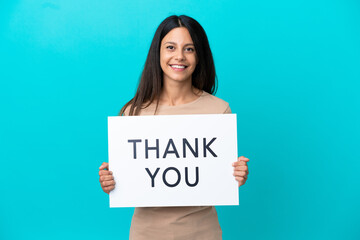 Poster - Young woman over isolated background holding a placard with text THANK YOU with happy expression