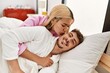 © Krakenimages.com - Young caucasian couple kissing and hugging lying on the bed at home.