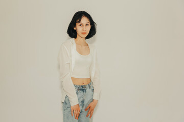 Young cute teen girl in jeans and shirt on a white background