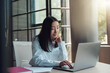 © Kostiantyn - Attractive asian businesswoman working on laptop at modern office