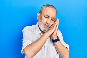 Sticker - Handsome senior man with beard wearing casual white shirt sleeping tired dreaming and posing with hands together while smiling with closed eyes.