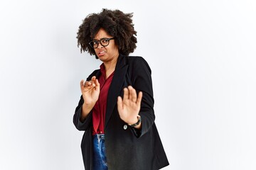 Wall Mural - African american woman with afro hair wearing business jacket and glasses disgusted expression, displeased and fearful doing disgust face because aversion reaction.