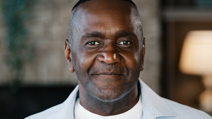 Elderly male portrait indoors of african american adult 50s man biracial senior businessman confident handsome mature grandfather bachelor middle-aged customer parent wrinkled face looking at camera