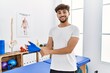 © Krakenimages.com - Young arab man patient smiling confident wearing glove at clinic