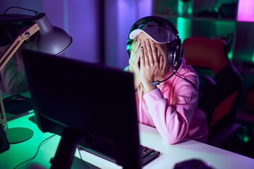 Poster - Young blonde woman streamer stressed using computer and headphones at gaming room