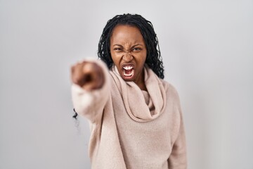 Sticker - African woman standing over white background pointing displeased and frustrated to the camera, angry and furious with you