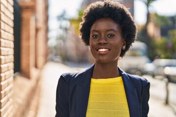 Young african american woman business executive smiling confident at street