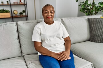 Sticker - Senior african american woman smiling confident sitting on sofa at home