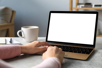 Canvas Print - Woman working on laptop at white table, closeup. Mockup for design