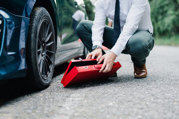 Asian businessman broken car engine breakdown his stressed emotion problem, Accident emergency on the mountain road outdoor late for work concept.