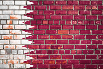 Wall Mural - National  flag of the Qatar on a grunge brick background.