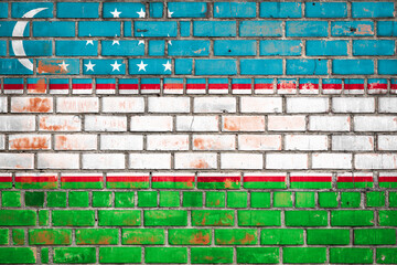 Wall Mural - National  flag of the Uzbekistan on a grunge brick background.