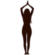 Silhouette of a woman with long hair practicing yoga in a standing position