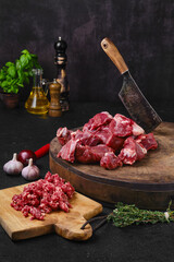 Wall Mural - Chopping fresh beef meat on wooden chopping stump