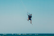 © Westend61 - Mature man kiteboarding mid-air over sea on sunny day