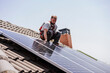 © Westend61 - Technician installing solar panels on rooftop