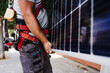 © Westend61 - Technician carrying heavy solar panel