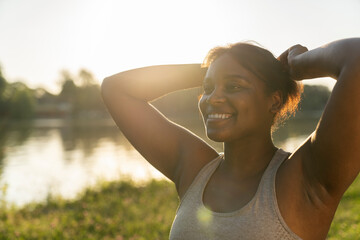 Wall Mural - Smiling African American preparing for workout at the park in summer day