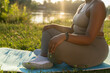 © gpointstudio - Low section of African American woman practicing meditating at the park
