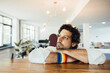 © Westend61 - Thoughtful businessman leaning on desk at workplace