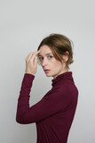 Fototapeta Konie - Serie of studio photos of young female model wearing beige turtleneck made from organic cotton. Comfortable sustainable fashion