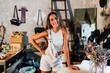 © Westend61 - Happy fashion designer standing with hand on hip at workshop