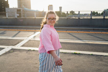Confident Teenage Girl With Down Syndrome Walking On Street