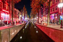 Netherlands, North Holland, Amsterdam, Long Exposure Of Canal Stretching Along De Wallen Red Light District At Night
