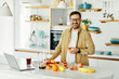 © Lumos sp - man kitchen food fruit laptop recipe juice smoothie healthy home happy cooking home computer instruction drink morning breakfast