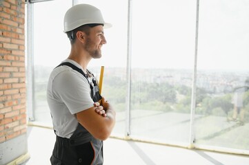 Wall Mural - profession, construction and building - male worker or builder in helmet.