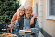 © Drazen - Happy senior couple at independent living community looking at camera.