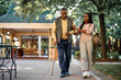 © Drazen - Happy African American woman walks with her senior father while visiting him at nursing home.