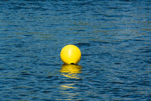 Inflatable Yellow Buoy In A Blue Water