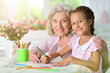 © aletia2011 - Portrait of a cute little girl drawing with her grandmother