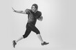 © master1305 - Dynamic portrait of american football player in action and motion isolated on white background. Concept of sport, achievements, retro style. Monochrome