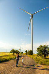 Father and daughter having fun, playing with kite together on the Wheat Field on Bright Summer day