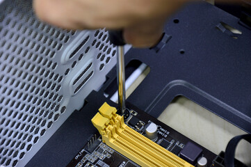 Poster - picture during assembly One corner of the motherboard, tightening the screws.