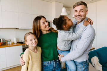 Happy family on cozy kitchen at home. Adoption concept