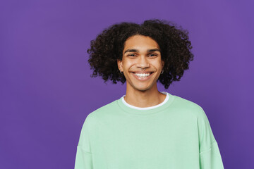 Young caribbean man with piercing smiling and looking at camera