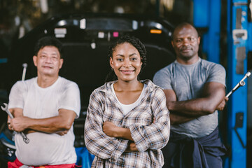 Wall Mural - group of people mechanic with woman car owner customer standing happy smile together for good auto service garage concept