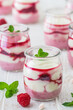 Fruity quark dessert with raspberries in small glasses
