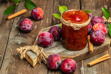 Wall Mural - plum jam nd fresh plums on a wooden background. banner, menu, recipe place for text