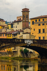 Wall Mural - Bridge Ponte Santa Trinita over Arno river and Church of Saint James on the Arno in Florence.