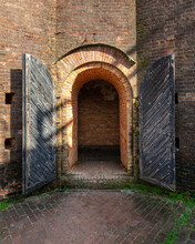 Arched Brick Doorway With Black Doors