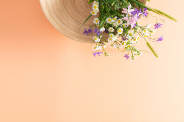 Wall Mural - autumn composition. bouquet of wild flowers in bowl on isolated beige background. autumn, fall conce