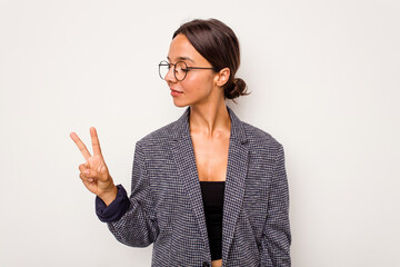 Poster - Young hispanic woman isolated on white background joyful and carefree showing a peace symbol with fingers.