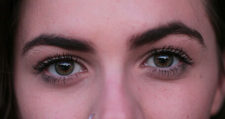 Macro close-up of girl eyes. Young woman closing and opening eyes