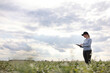 © Andriy Medvediuk - a female agronomist with a tablet checks the growth of a field with buckwheat flowers. the woman examines the field and enters the data into a digital tablet. Modern agribusiness.