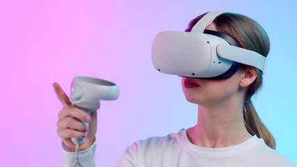 Poster - Close up of young woman in vr goggle moving hand with controller isolated over neon background