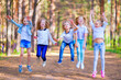© R - A group of girls having fun in the forest.